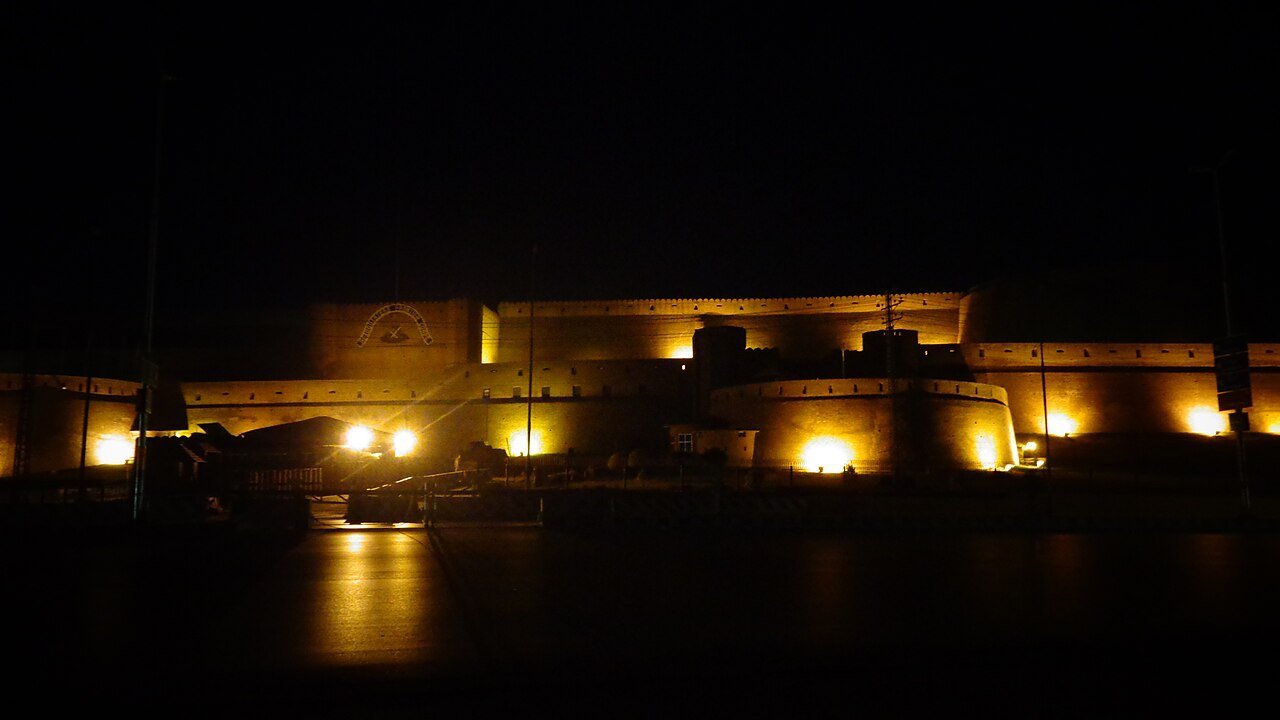 Stand-in, not a photo of this event: a 2014 night view of the floodlit walls and round bastions of Bala Hisar Fort in Peshawar, Khyber Pakhtunkhwa