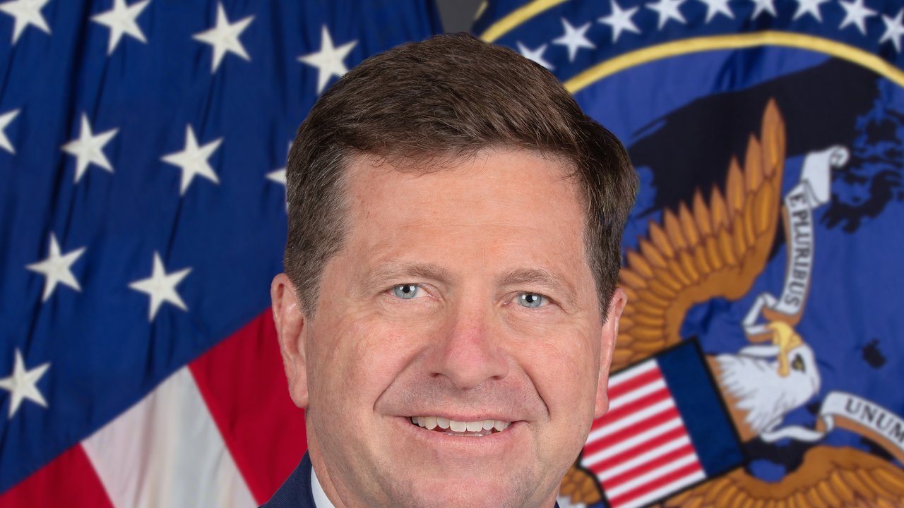Jay Clayton’s 2026 official portrait as director of national intelligence: a smiling man in a dark suit in front of a U.S. flag and the ODNI seal; a file portrait, not a photo of this announcement