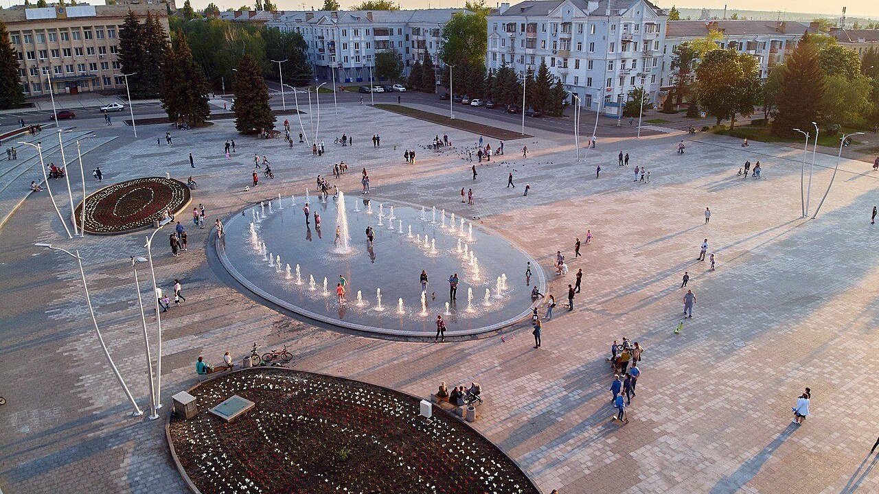 Stand-in, not a photo of this attack: Myru Square in Kramatorsk under a summer sky in a July 2019 file photo, with trees, buildings, and open pavement