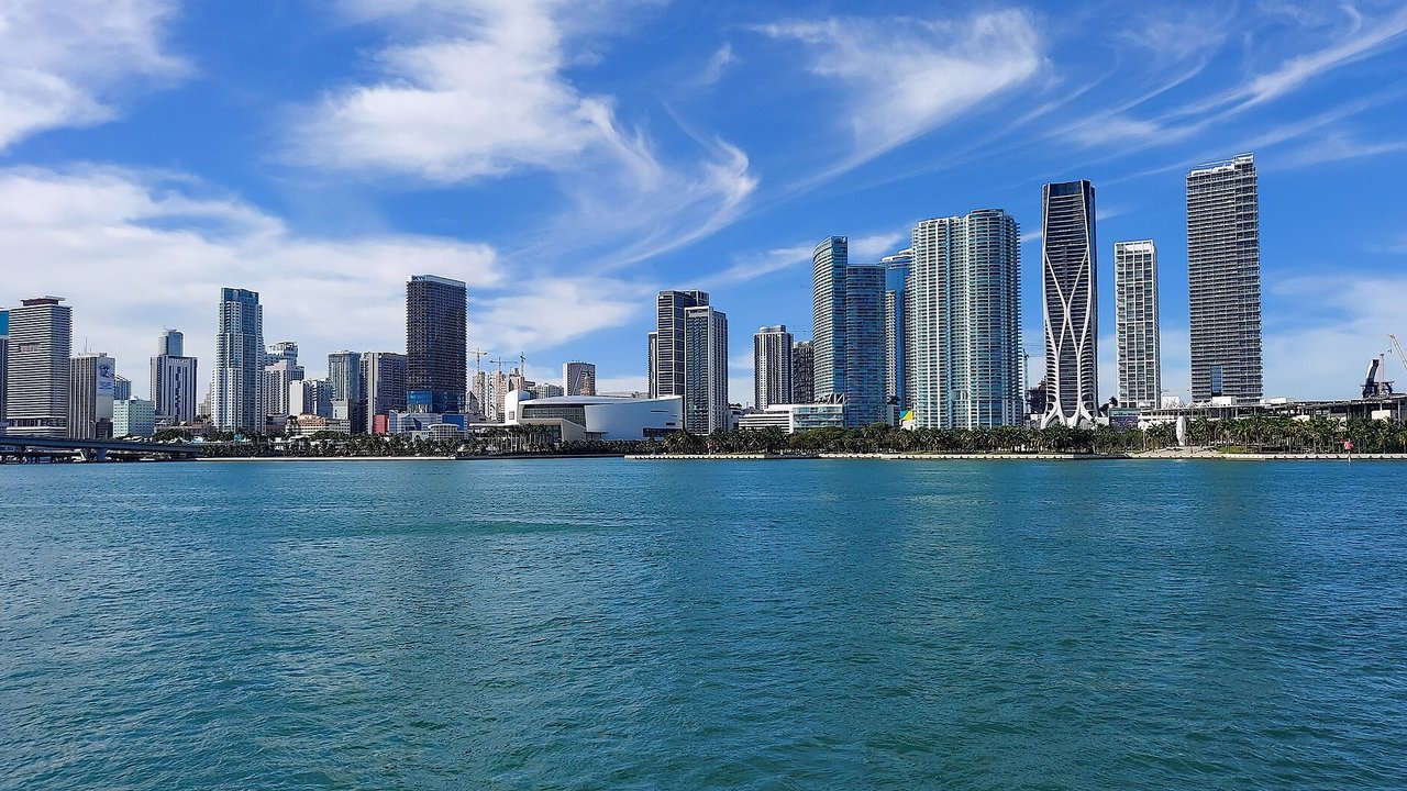 Stand-in, not a photo of the talks: a December 2023 file photo of the downtown Miami skyline seen across Biscayne Bay under a blue sky