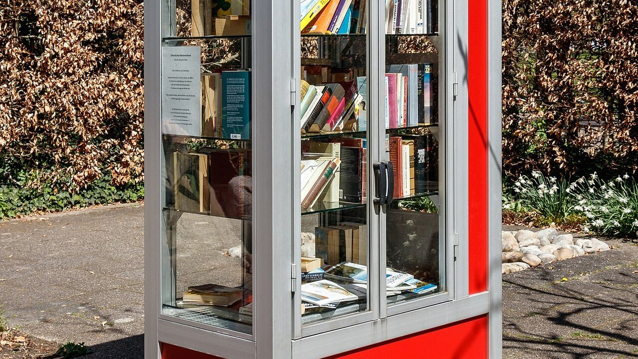 Stand-in: a red public bookcase full of books in a Karlsruhe park in an April 2018 file photo, not tied to any person in this story