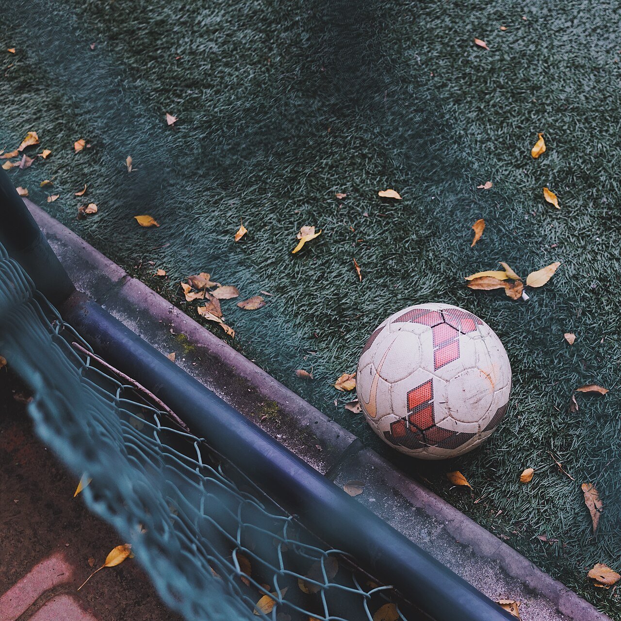 Football on fall ground (Unsplash) — free Wikimedia Commons media