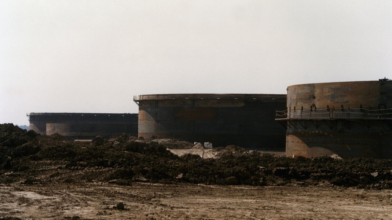 Stand-in, not a photo of this event: undated archival U.S. Department of Energy photo of large crude oil storage tanks at the Strategic Petroleum Reserve’s St. James terminal in Louisiana, seen across bare, churned earth